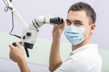 Dentist and a dental microscope