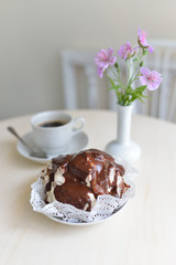 Cake with chocolate cream on light background in cafe