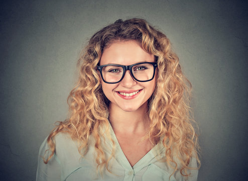 Headshot of a happy smiling woman in glasses