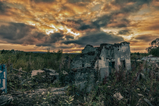 Apocalyptic landscape.The remains of destroyed houses at sunset