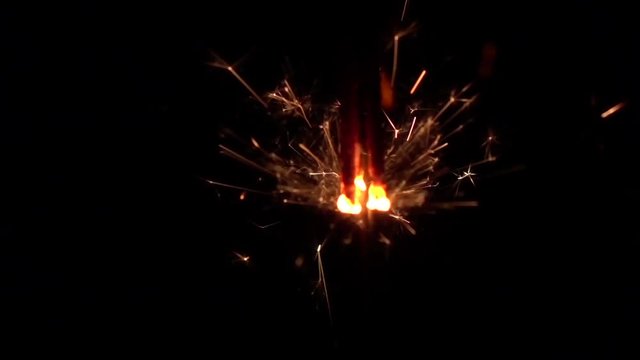 Sparklers burning on a black background. Slow motion