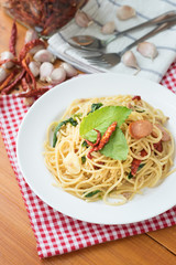 Spicy spaghetti with sausage, basil and chilli