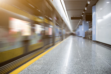 Blurred view of train leaving platform in city of China.