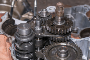 Gear metal wheels close-up. Industrial mechanism - inside of motorcycle engine 
