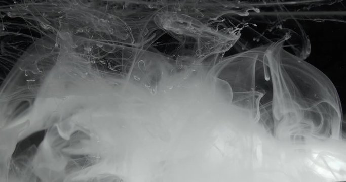 White Ink Effect In Water Filmed On Black Background. Abstract ink creating wonderfully unique cloud formations. Great for luma mattes or alien environments. Filmed in 4K for super Hi Def 