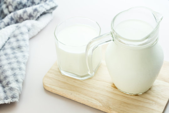 Glass jug and glass with milk