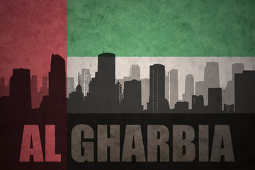 abstract silhouette of the city with text Al Gharbia at the vintage united arab emirates flag background