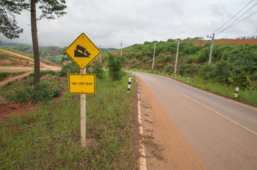 warning steep road sign slope and truck on hill