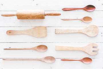 Wooden kitchen utensils on white  wooden background