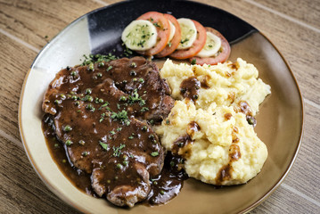 beef steak meal with mashed potato and gravy sauce