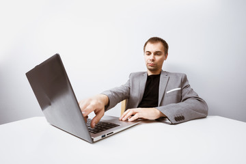 Handsome businessman working with laptop in office