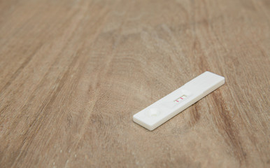 Pregnancy test kit on a wooden desk