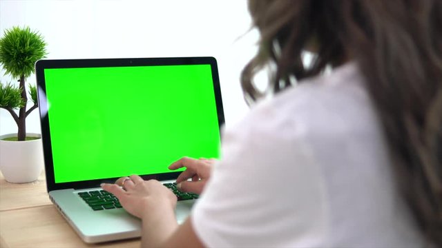 Asian Woman Using A Green Screen Notebook Computer