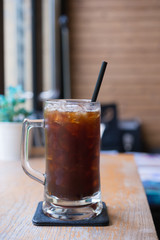 Iced Americano black coffee on a wooden table. shallow depth of
