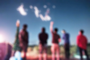 Blurred scene group of friends celebrating with fireworks