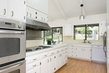 Classic White Kitchen with Wooden Floor and Silver Appliances