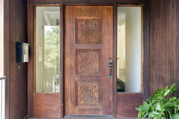 Ornate Wooden Door at Entrance of Modern Home