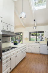 Classic White Kitchen with Wooden Floor Silver Appliances and Na