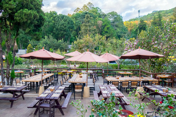 Tables and chairs prepare for dinner in restaurant shady garden