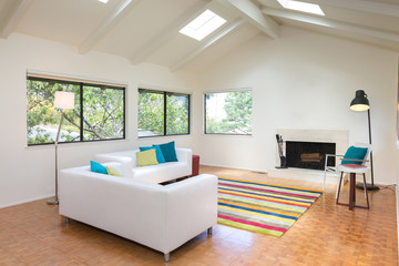 Bright and Spacious Simple White Living Room with Natural Sky-li