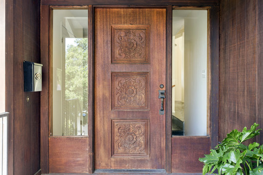 Ornate Wooden Door At Entrance Of Modern Home