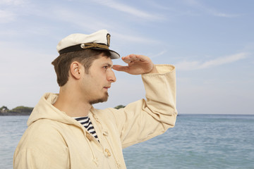 Travel and marine concept - man in captain hat