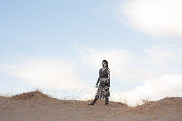 Futuristic zebra woman in sand dunes