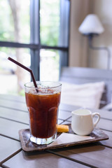 Iced Americano black coffee on a wooden table. shallow depth of