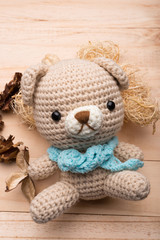 Knitted teddy bear on wood background