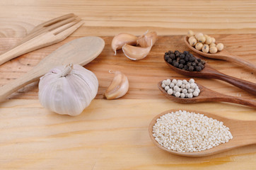 Pepper, sesame seeds with a wooden spoon