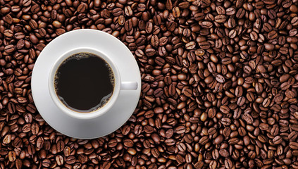Coffee cup on roast coffee bean with text copy space.