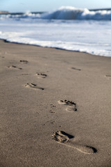 Fototapeta na wymiar Footprints on the beach of Half Moon Bay, California