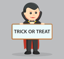 dracula.holding trick or treat sign