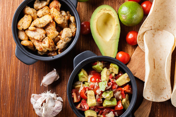 Ingredients ready for preparing chicken tacos with salsa made fr