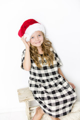 Happy christmas girl in Santa hat on white background