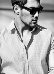 High fashion look.Young stylish confident happy handsome businessman model in suit clothes lifestyle in the street in sunglasses