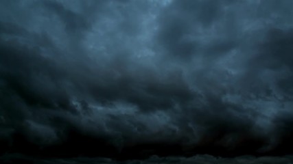 Night sky. The huge dark storm clouds. Dark blue night sky with clouds