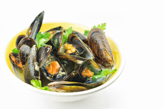 Mussel soup and fresh parsley leaves with  copy space