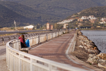 Girl looks into the distance on the Orbetello lagoon