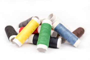 Pile of colorful threads over white background
