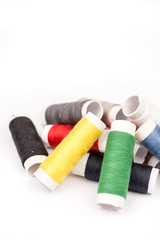 Pile of colorful threads over white background