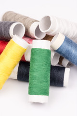 Pile of colorful threads over white background