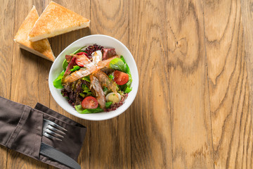 Tuscan salad of lettuce, egg and prosciutto jerky.