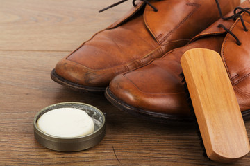 Shoes and cleaning equipment on a wooden floor