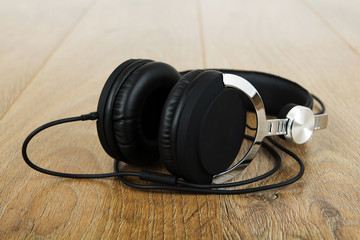 Pair of headphones on a rustic wooden surface