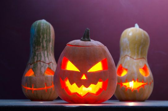 Several smiling pumpkins with candles, Halloween.