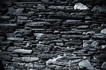 Detail of a wall of an ancient stone house. Toned