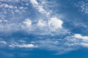 Naklejka na ściany i meble White clouds on a blue sky. Selective focus