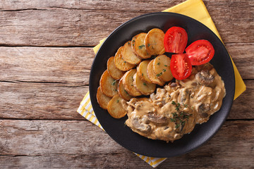 Diana steak garnished with fried potatoes close-up. Horizontal top view
