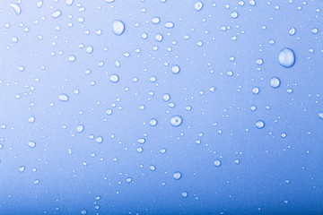 Drops of water on a color background. Blue. Toned